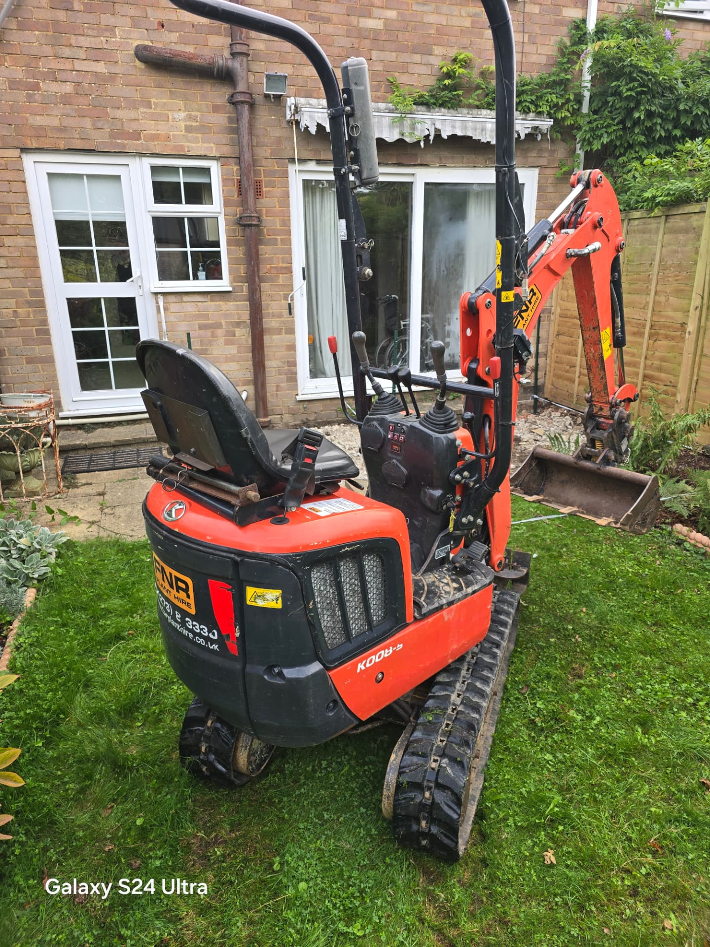 Micro digger working in a residential back garden in Lewes