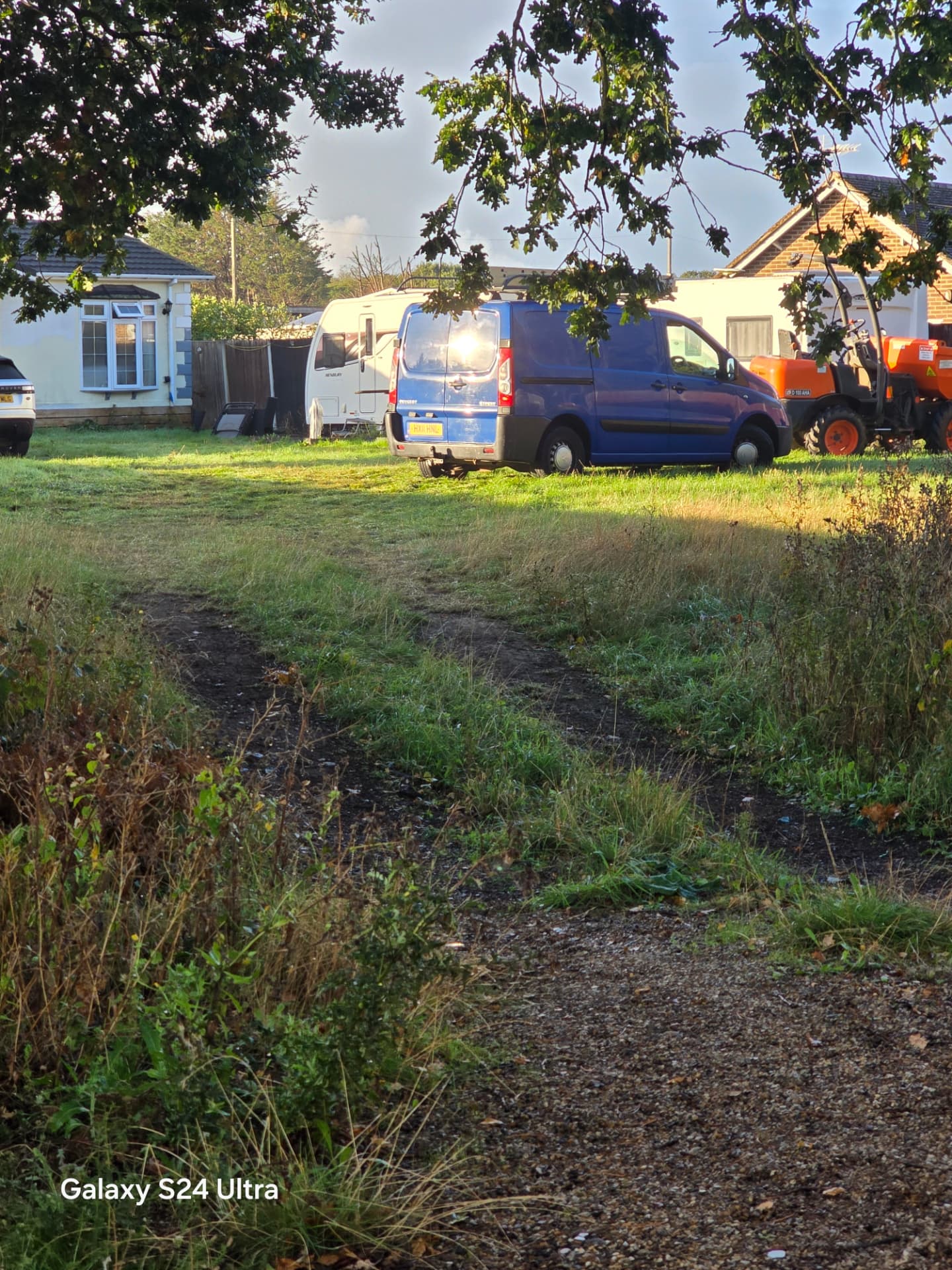 Closer view of the existing access track, vehicles and digger before site work near Emsworth