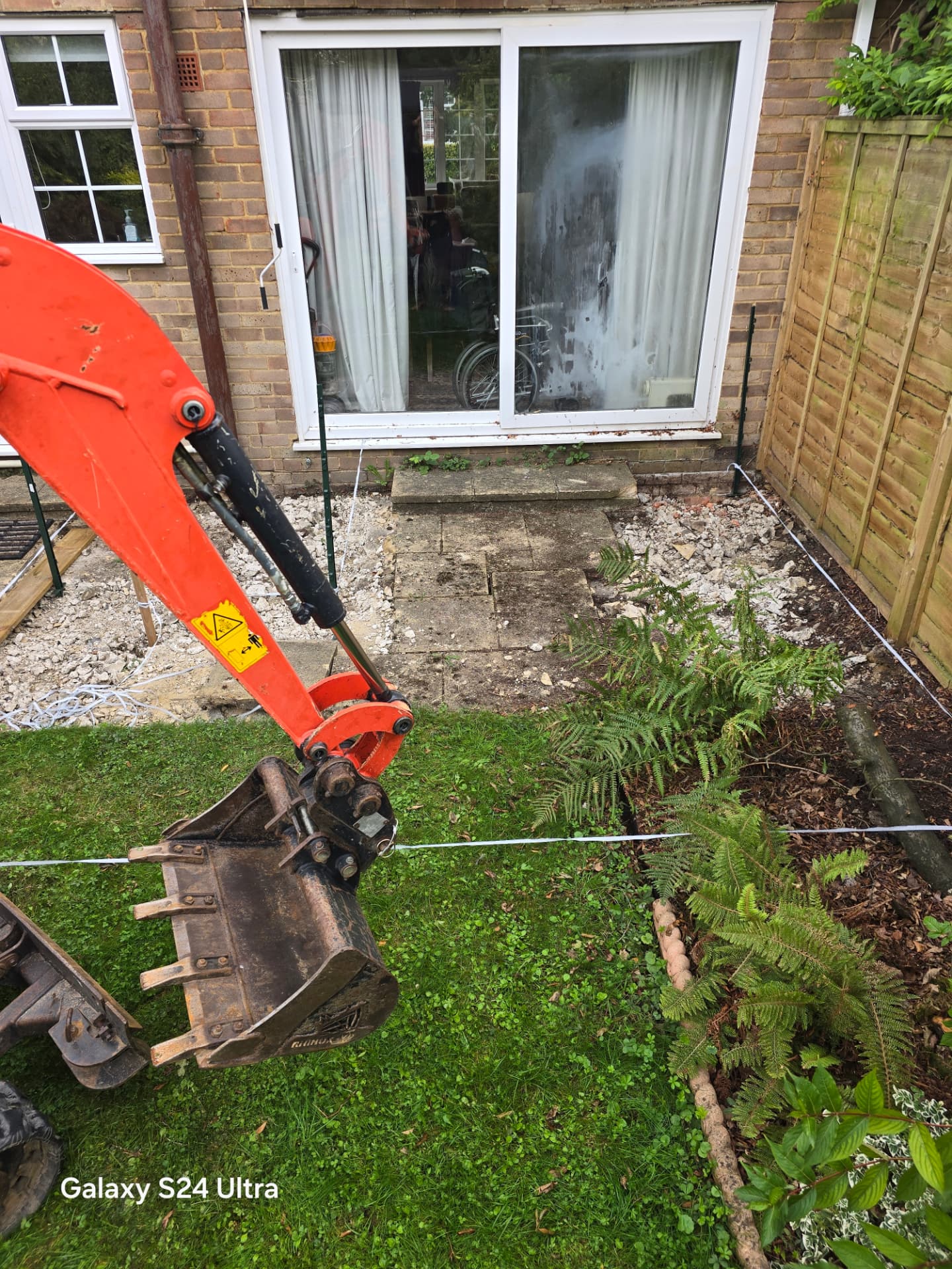 Micro digger bucket digging out footings in a Lewes garden