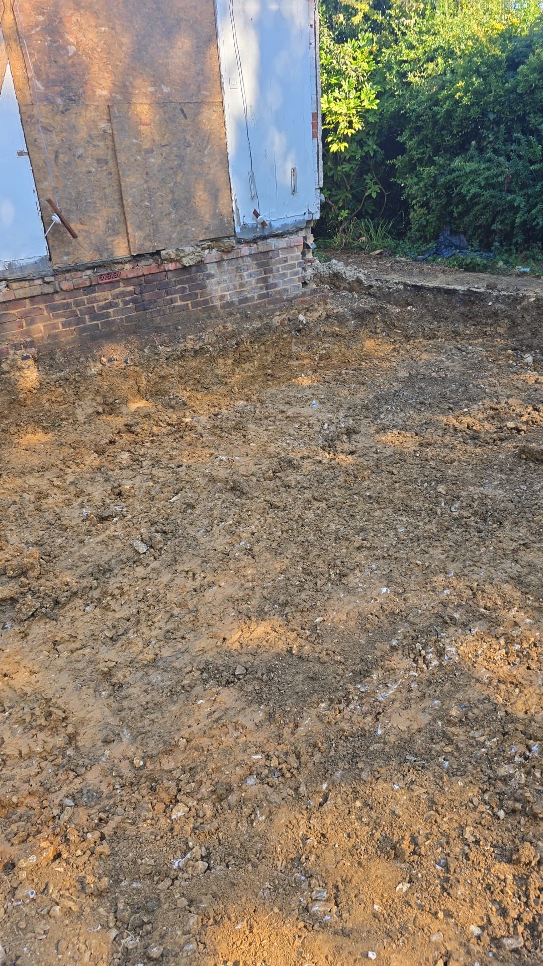 Dug-out and prepared ground alongside building in Worthing