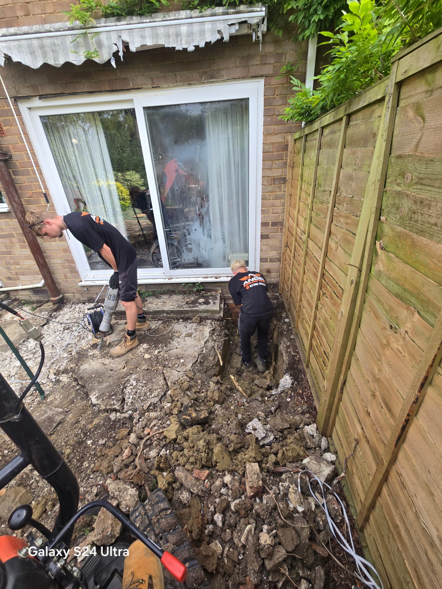 Footings trench being dug alongside a house in Lewes